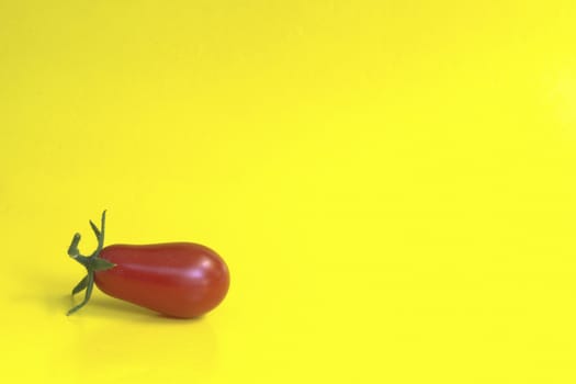Cherry tomatoes on a yellow background