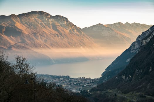 Sunset in the mountains surrounding Lake Garda and views of the town of Riva del Garda, Italy