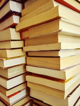 Stack of old books in warm daylight.