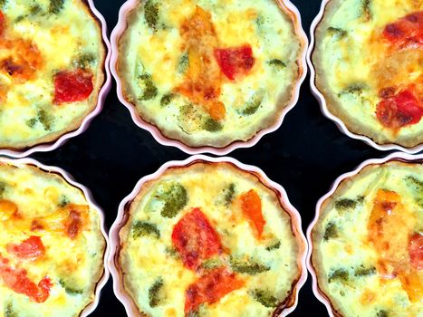 Freshly baked vegetable pies with broccoli, paprika and cheese.