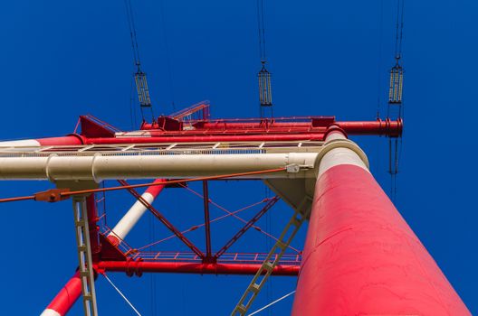 supports of high-voltage power lines against the blue sky