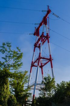 supports of high-voltage power lines against the blue sky