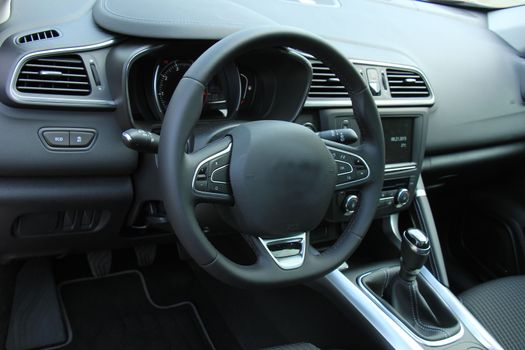 Modern car interior, luxurious materials in different shades of grey