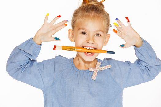 A little painter with colored fingers and a charming smile