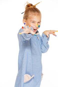 A little painter with colored fingers and a charming smile