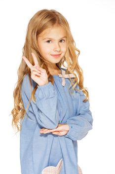 Little girl posing for the camera with the peace sign