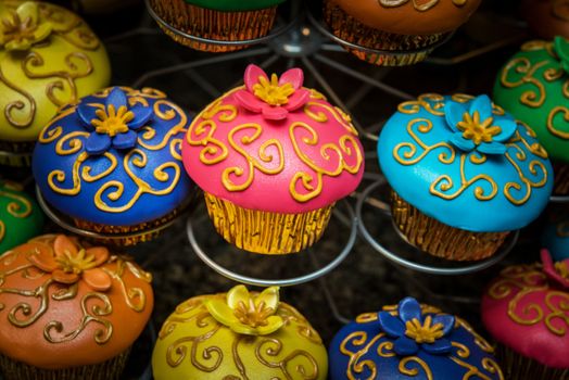 Image of very colorful cupcakes on a stand