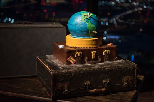 Wedding cake in shape of the world on a suitcase