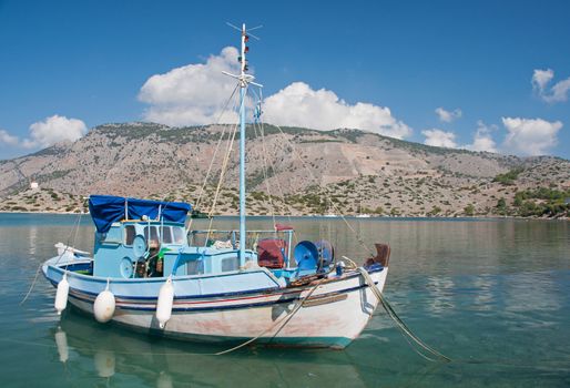 Greek fishing boat anchored at Panormitis Monastery on the Mediterranean Greek island of Symi, near Rhodes. 