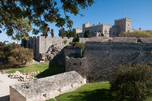 Palace of the Grand masters viewed from Dimokratias lookng across Old Town Moat near Saint Georges Gate, Rhodes Tow, Rhodes Island, Greece