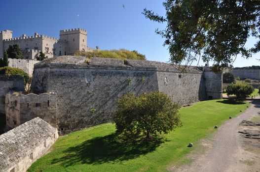 Palace of the Grand masters viewed from Dimokratias lookng across Old Town Moat near Saint Georges Gate, Rhodes Tow, Rhodes Island, Greece