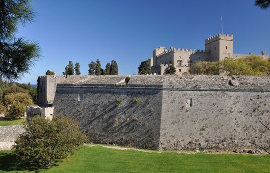 Palace of the Grand masters viewed from Dimokratias lookng across Old Town Moat near Saint Georges Gate, Rhodes Tow, Rhodes Island, Greece