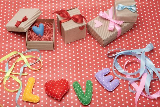 Love, Valentines Day. Word Love polka dots, Heart Handmade and stack of gift boxes, ribbons. Retro vintage romantic style, toned. Vivid unusual creative art greeting card, multicolored felt, copyspace