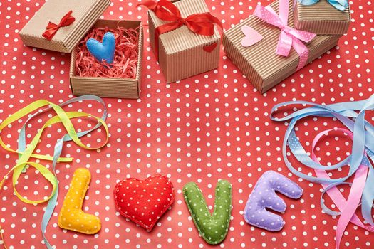 Love, Valentines Day. Word Love polka dots, Heart Handmade and stack of gift boxes, ribbons. Retro vintage romantic style, toned. Vivid unusual creative art greeting card, multicolored felt, copyspace