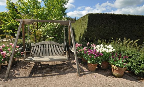 Garden furniture an English style garden. Taken at RHS Rosemoor, Torrington, North Devon, England