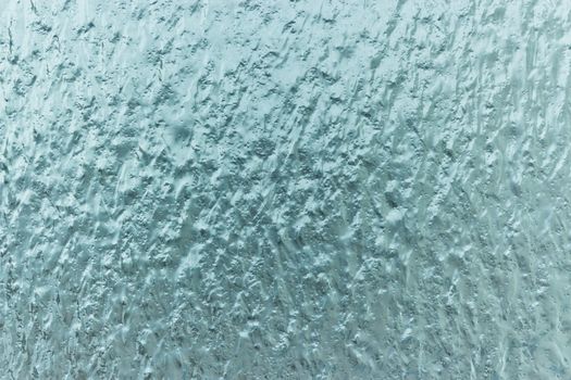 Splashes of ice frozen rain on glass
