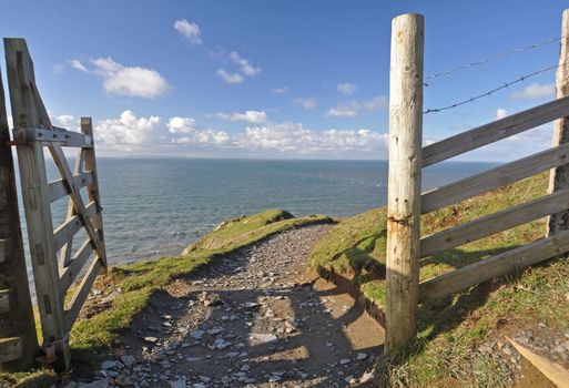Southwest Coast footpath at Baggy Point headland, Croyde, North Devon, England, a popular walk throughout the year, ths Island of Lundy is visible on the horizon