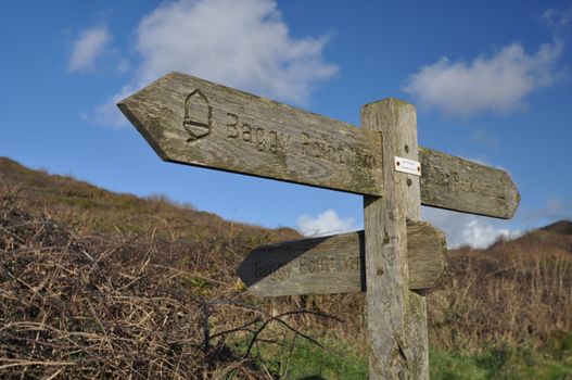 Direction sign on the Southwest Coast footpath near Baggy Point headland, Croyde, North Devon, England