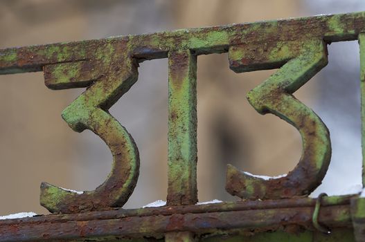 Number 33 on gate. Decoration on a fence. Exterior