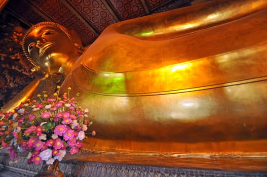 Reclining Buddha  is at Wat Pho, Bangkok, Thailand. The statue is 46 (150 feet ) meters long and covered n gold leaf. Wat Pho is Bangkoks oldest and largests temple.