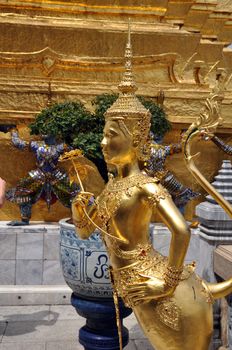 Apsonsi a mythical half woman half lion Creature one of the beautiful gilded figues on the upper terrace of Wat Phra Kaeo Grand Palace Bangkok