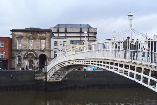 DUBLIN, IRELAND - JANUARY 05: Perspective view of Ha'penny Bridge over Liffey river. The bridge is the main access point to the touristic area of Temple Bar. January 05, 2016 in Dublin