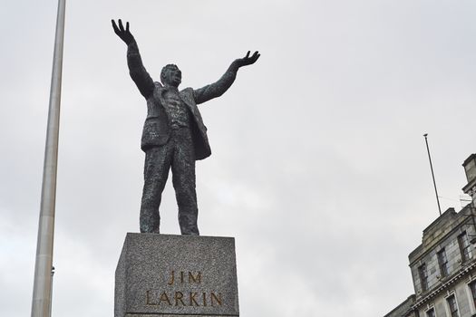 DUBLIN, IRELAND - JANUARY 05: Statue of Jim Larkin with Millennium Spire in the background, in overcast day. January 05, 2016 in Dublin