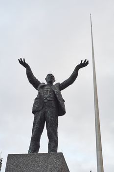 DUBLIN, IRELAND - JANUARY 05: Statue of Jim Larkin with Millennium Spire in the background, in overcast day. January 05, 2016 in Dublin