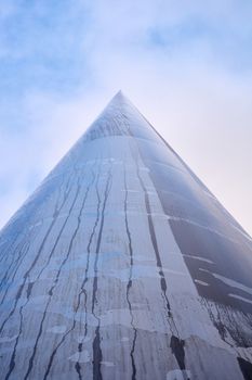 DUBLIN, IRELAND - JANUARY 05: Low angle shot of Millennium spire with treacles of water running down after the rain. Blue sky above. January 05, 2016 in Dublin