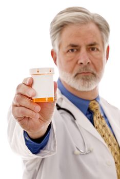 Portrait of doctor(not in focus)holding medicine bottle( in focus) with blank label for your copy.