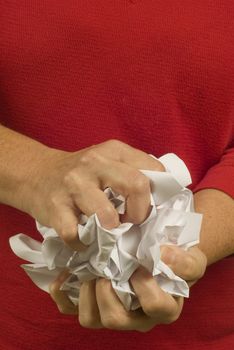 Vertical shot of woman crumpling paper.