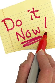 Close up shot of a hand writing in red marker saying DO IT NOW!