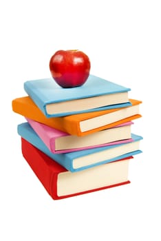 Uneven stack of colorful books with shiny red apple