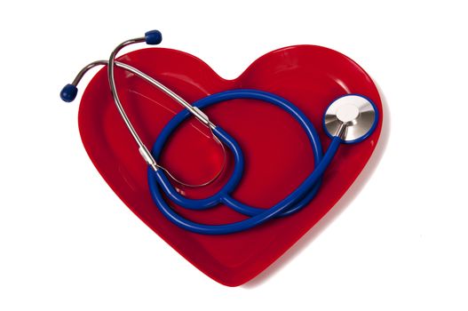 Stethoscope in a heart shaped tray.  Concept of taking care of and loving your heart
