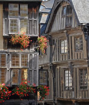 Medieval half-timbered buildings in the ancient french town of Dinan in Brittany. These old buildings are in the Place des Merciers (Haberdashers Square)~ One of  most visited by tourists