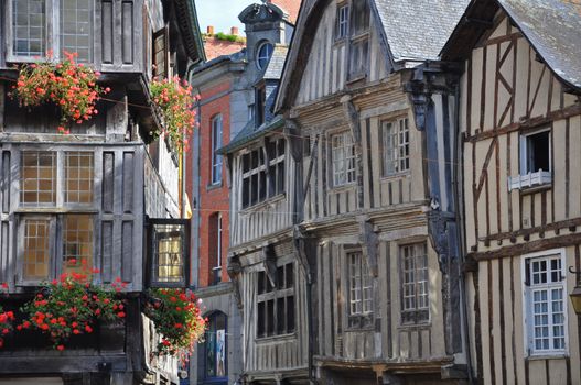 Medieval half-timbered buildings in the ancient french town of Dinan in Brittany. These old buildings are in the Place des Merciers (Haberdashers Square)~ One of  most visited by tourists