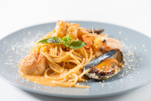 pasta with mussels, shrimp, scallop dressed with Thai style spicy sauce (Tom Yum)