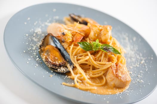 pasta with mussels, shrimp, scallop dressed with Thai style spicy sauce (Tom Yum)