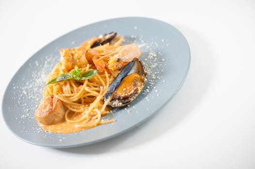 pasta with mussels, shrimp, scallop dressed with Thai style spicy sauce (Tom Yum)