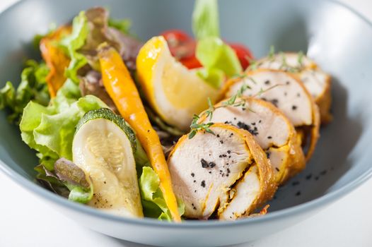 Modern style salad with roasted chicken breast roll