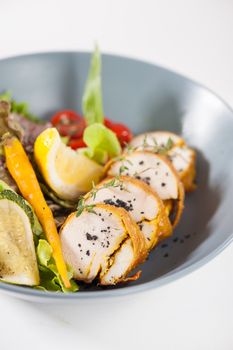 Modern style salad with roasted chicken breast roll