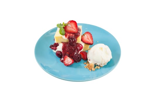 Yellow cake and vanilla ice cream dressed with strawberry sauce on blue dish isolated on white background with clipping path