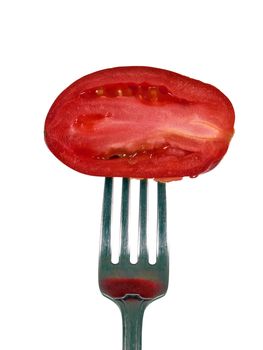 Vertical shot of a little tomato on a fork sliced opened