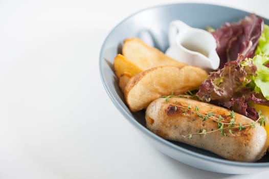 Grilled sausage with fried potatoes and salad