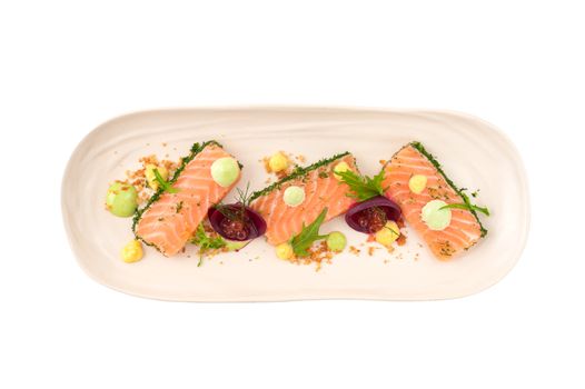 Smoked salmon with herbs, beetroot, faked salmon roe (sauce cooked by molecular gastronomy technic) garnished with mago sauce and wasabi mayo isolated on white background with clipping path