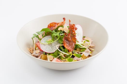 Vegetables and fruits salad with balsamic vinegar and navel orange dressing and smoked striploin ham 1.5 millimeters thickness in ceramic bowl, a modern cusine concept food