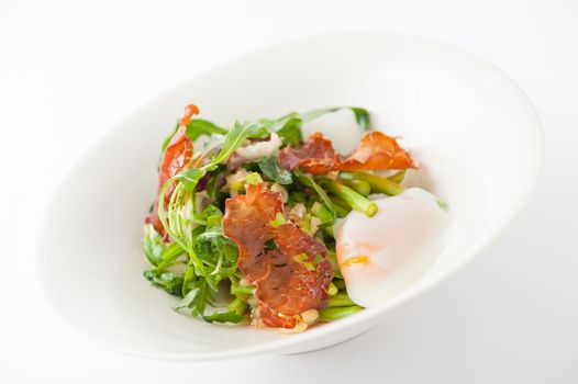 Vegetables salad with balsamic vinegar dressing, onsen tamago (Japanese style scald egg) and smoked striploin ham 1.5 millimeters thickness in ceramic bowl, a modern cusine concept food