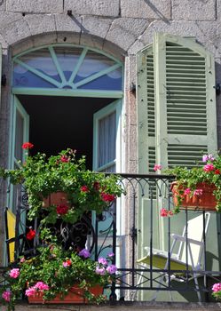 A beautiful balcony on a riverside house in the medieval town of Dinan in Brittany, France