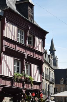 Medieval buildings in the ancient french town of Dinan in Brittany. These old houses are in the centre of the town and the, tour de l'horoge, clock tower, can be seen in the image.