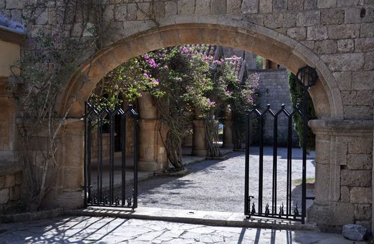 Gated entrance to the Cloisters and Medieval Frescoes at Ialyssos monastery on the Greek island of Rhodes. Built on the top of Mount Filerimos